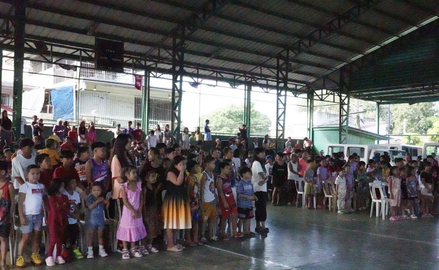 Children on their feet at the front as the morning session opens.