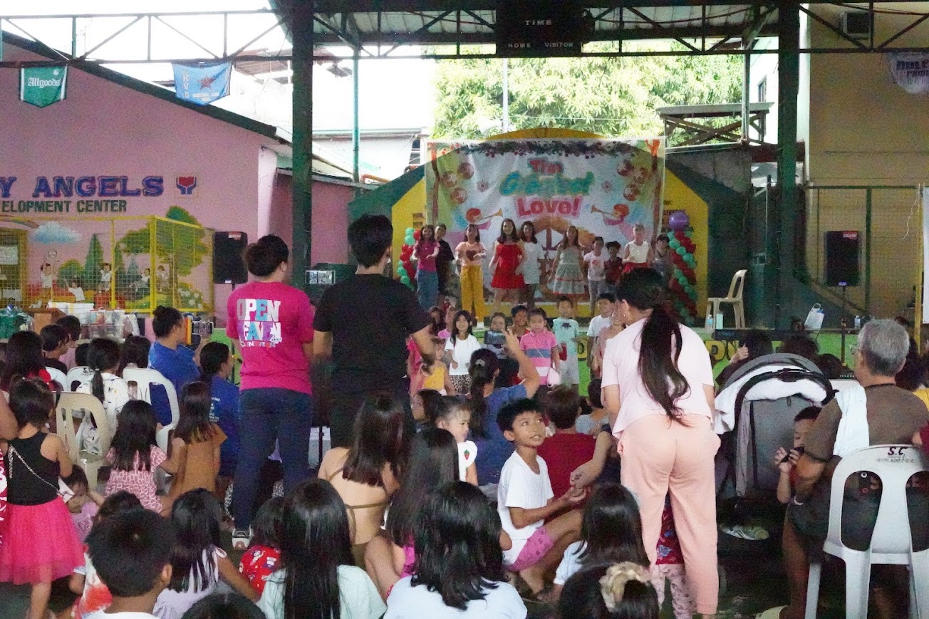 Children in the front rows, families in the stands behind.