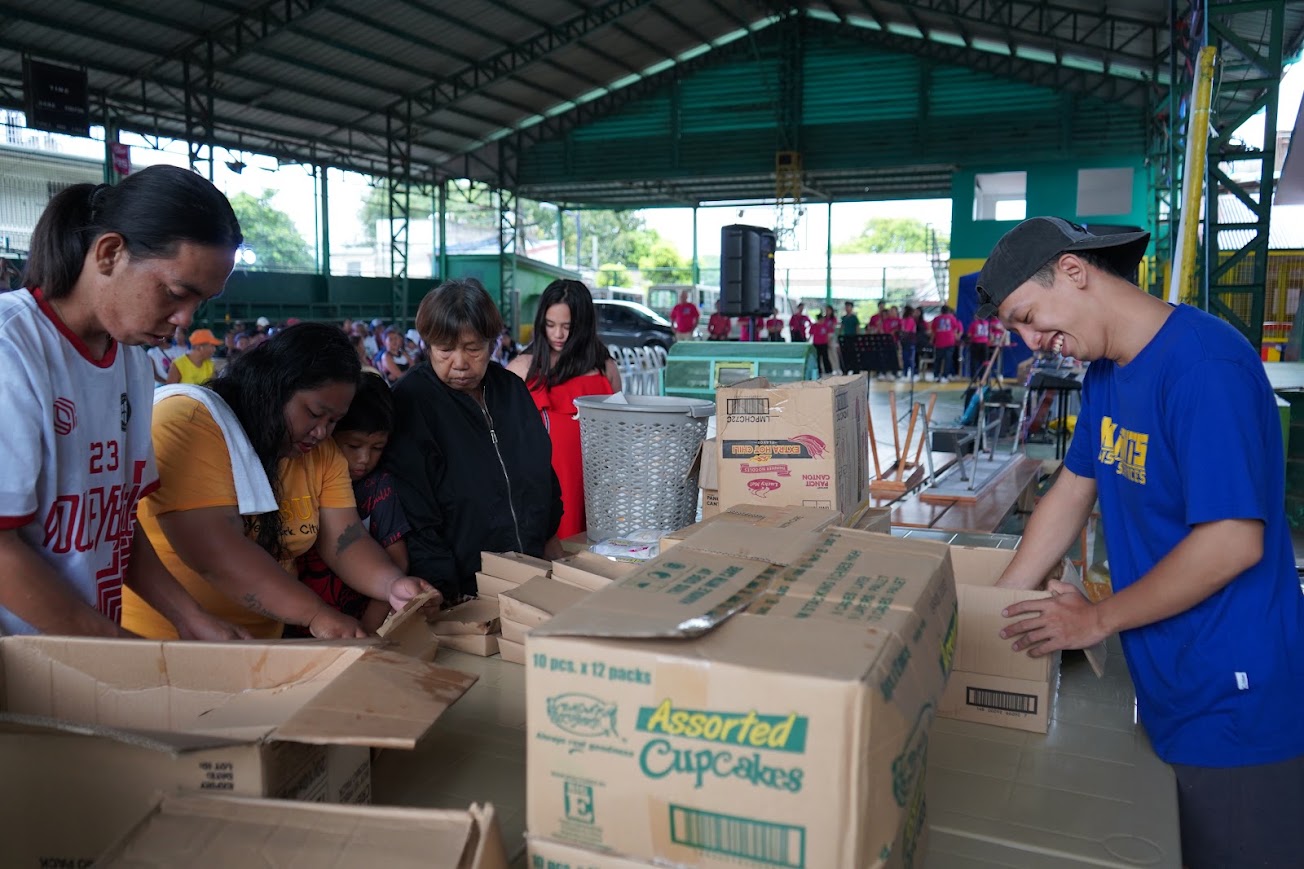 The registration team at their table, checking names and handing out wristbands.