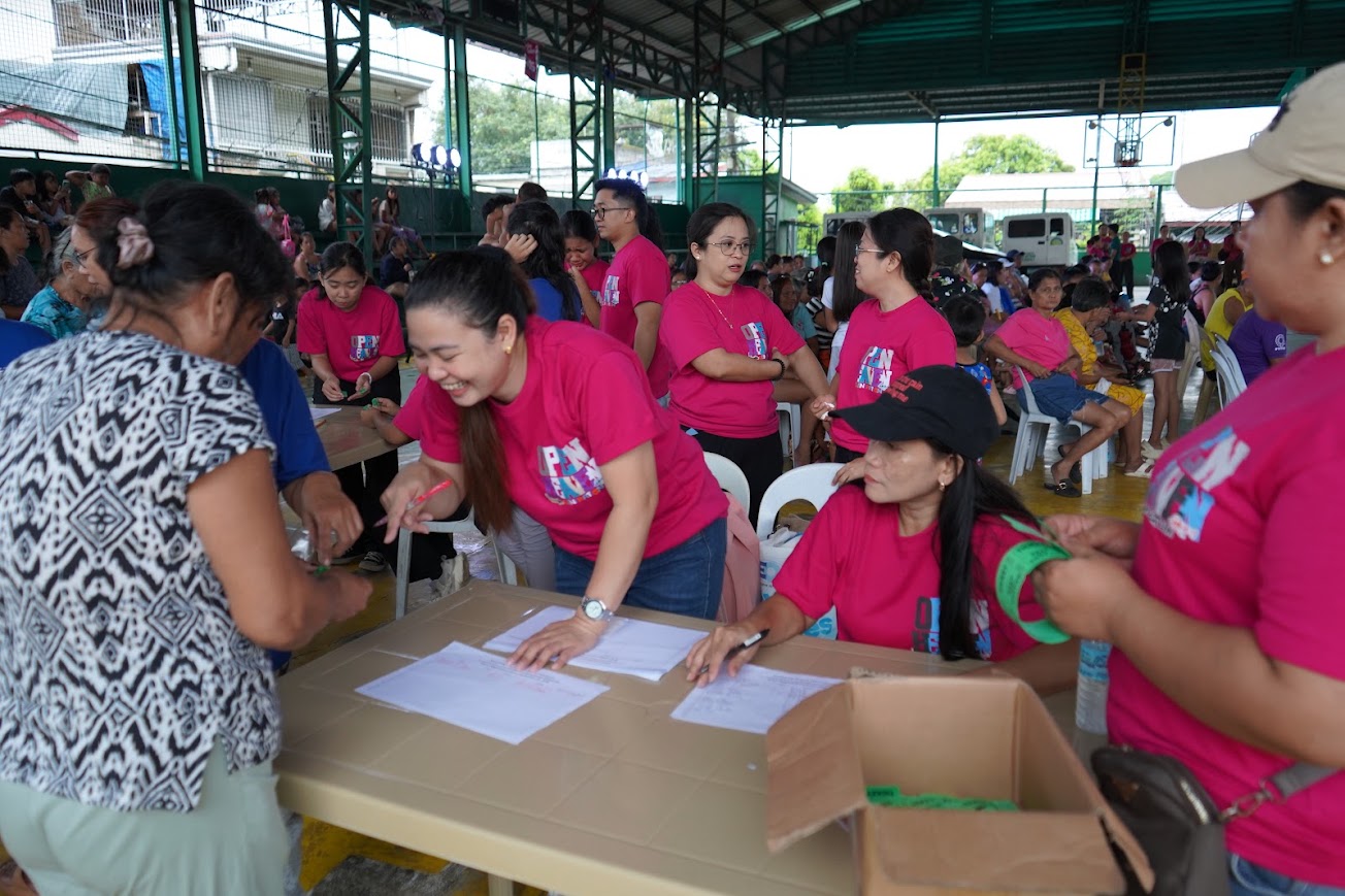 A community member signs in at registration.