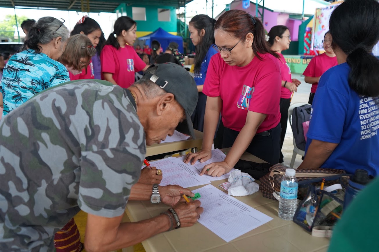 Registration under way, families lining up at the table.