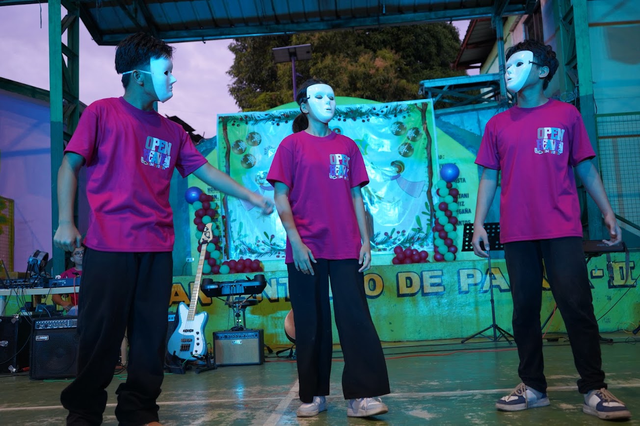 The masked dance team on stage as the performance begins.