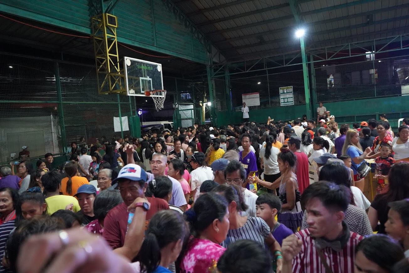The crowd at the boxes, elders at the front of the line.