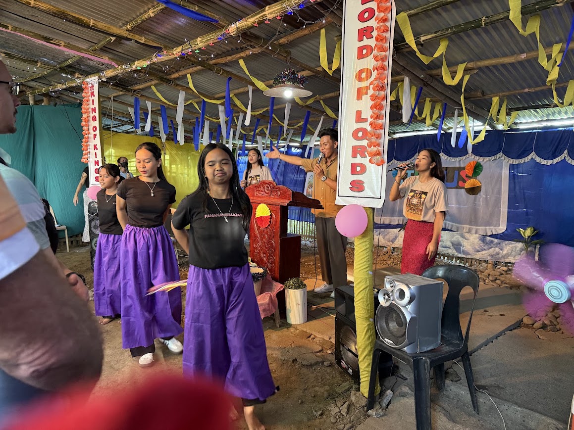 A worship dance team leads the congregation in celebration.