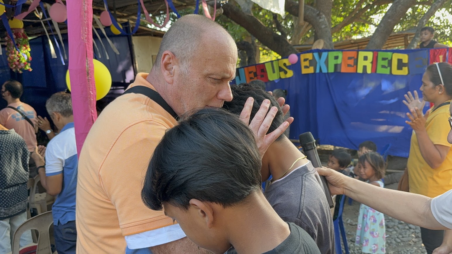 The seated congregation joins in a time of prayer.