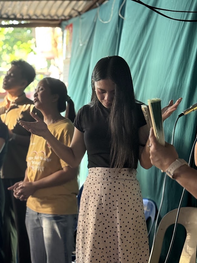 Worship continues as the congregation gathers in prayer.