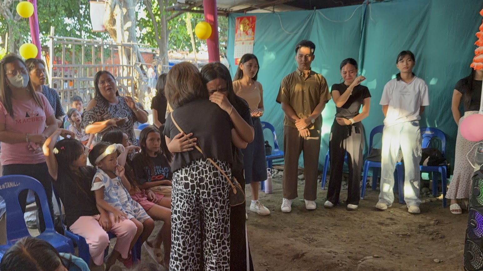 An embrace shared between two women during the evening's ministry.