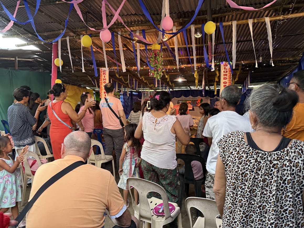 The community lingers in fellowship as the celebration winds down.