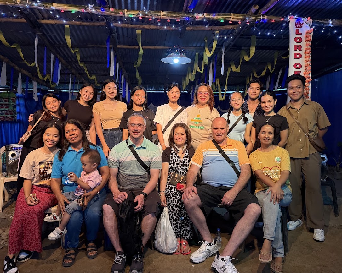 A final, closer group photo marking the end of a full day of ministry and fellowship.