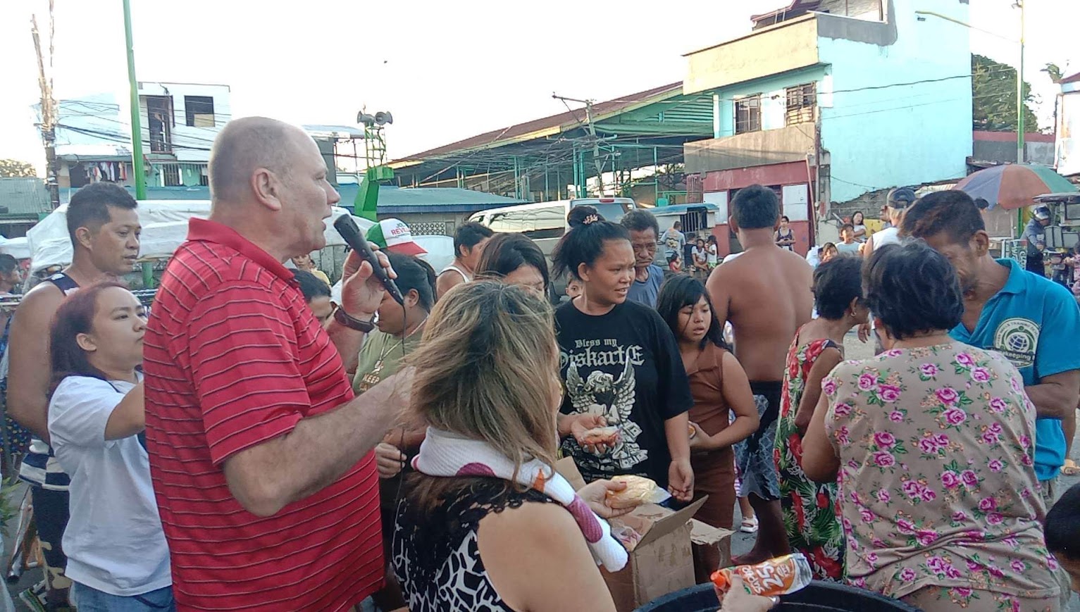 Juice pouches lifted from the bucket of ice and passed into the crowd.
