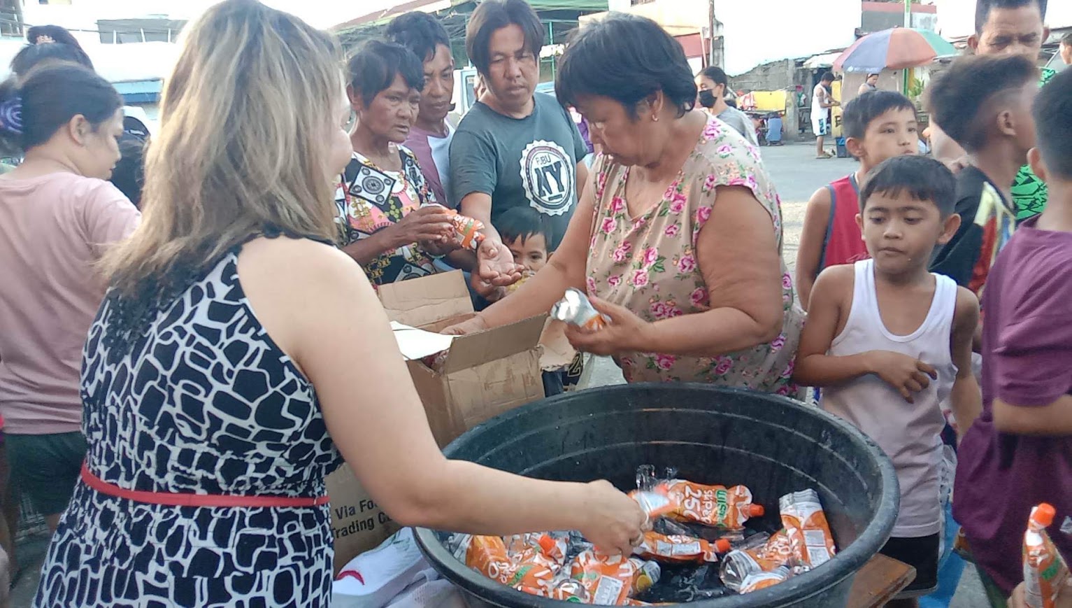 A juice pouch handed over the ice bucket to an elder.