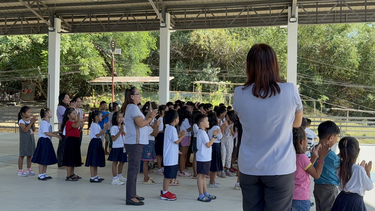 Students clap along during worship.