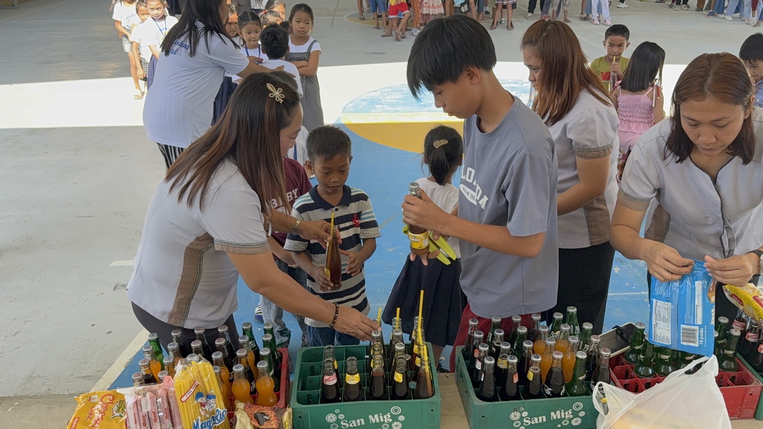 Handing out drinks and snacks to the children.
