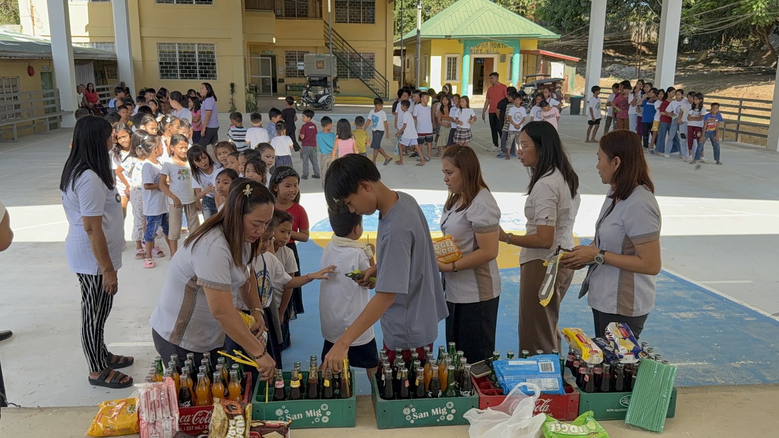 Children lining up for drinks and snacks.