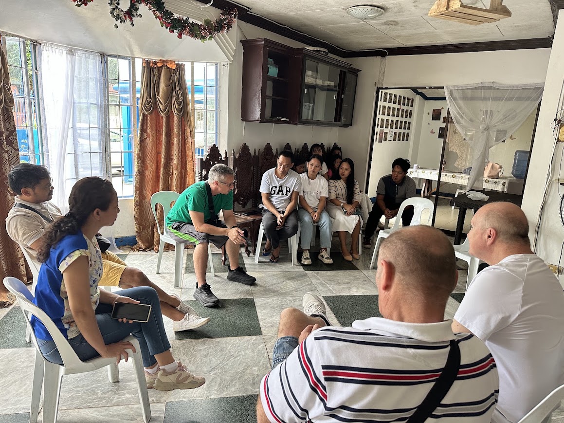 The team and local partners meet in a circle at the church.