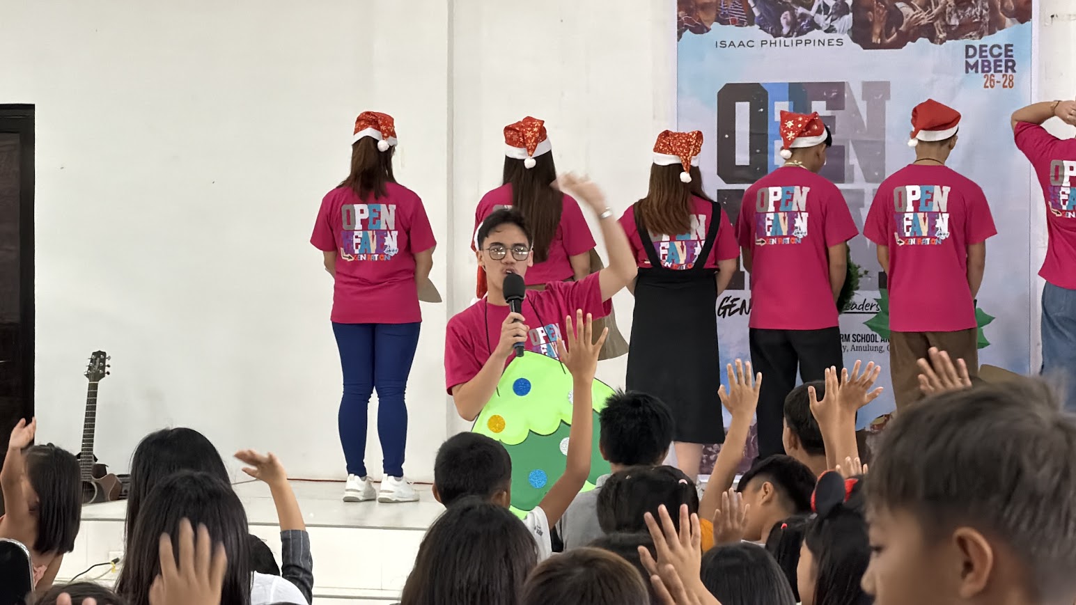 The tree steps forward as the narrator addresses the children, hands going up.