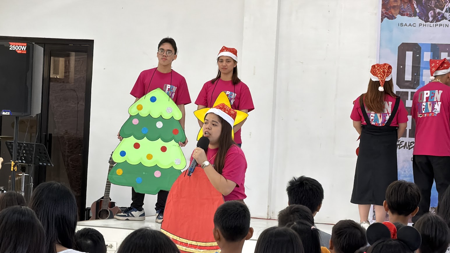 The bell speaks, the tree and star beside her.