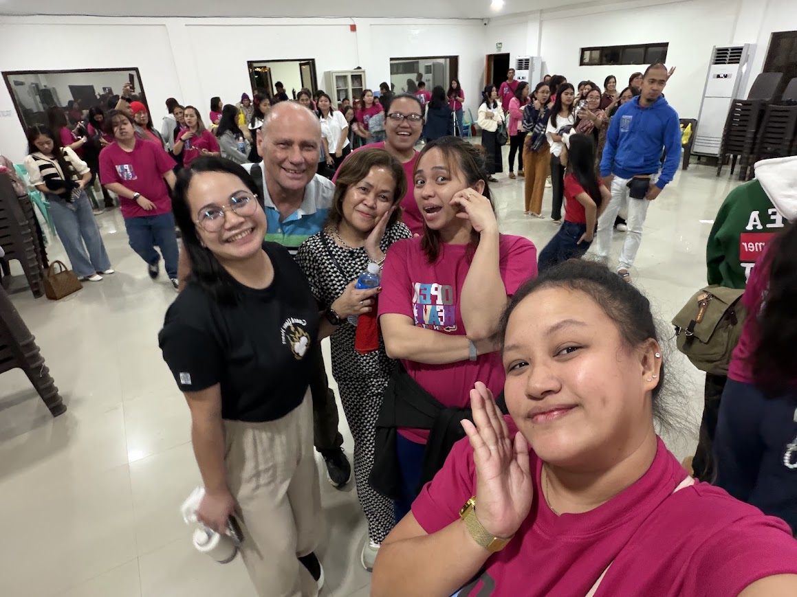 A team member's selfie with the leaders, the crowd milling behind.