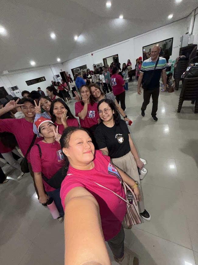 Youth volunteers, selfie down the length of the hall.
