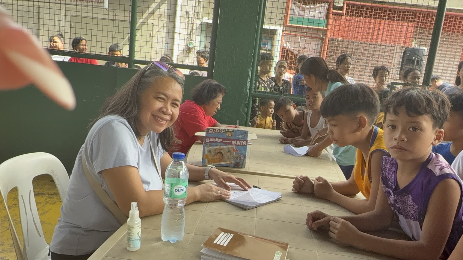 Families gather at the registration table as names are recorded.