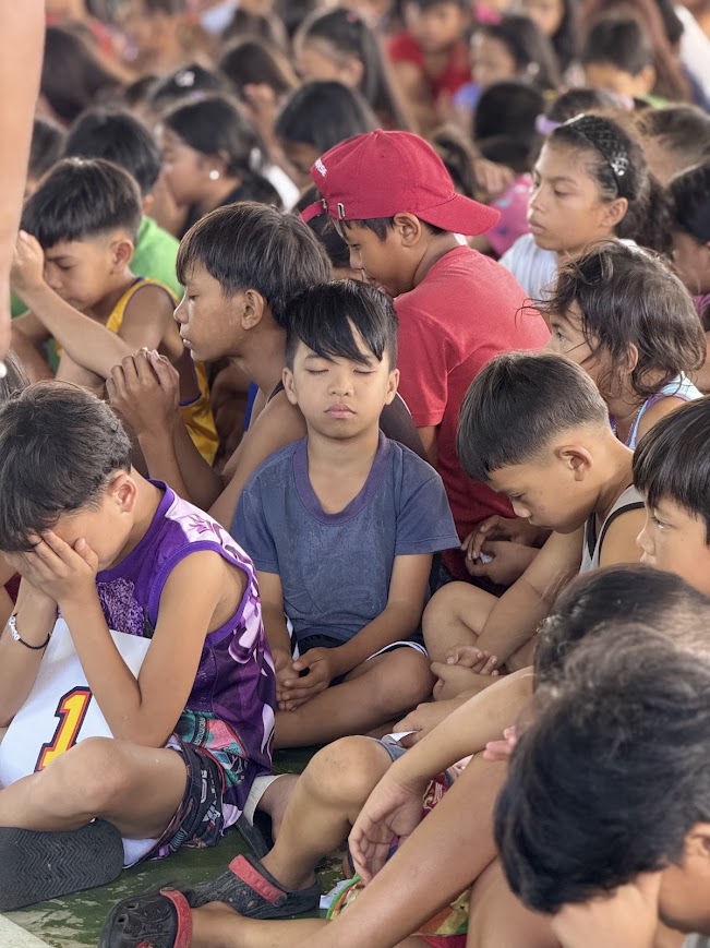 Two boys among the praying crowd.