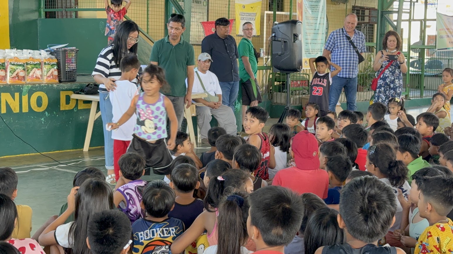 Children called to the front for an activity, the team at the stage.