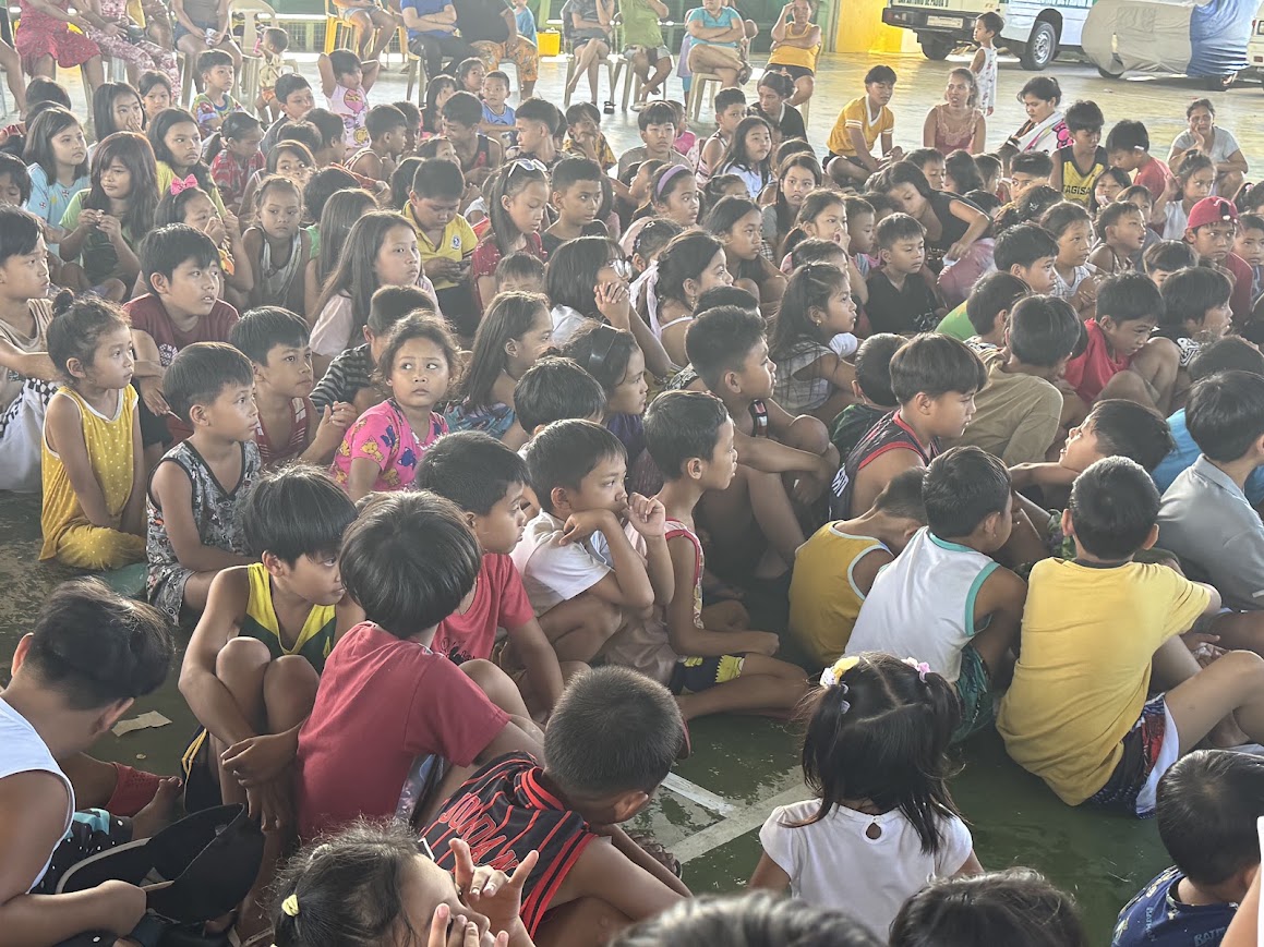 Seated children listening closely.