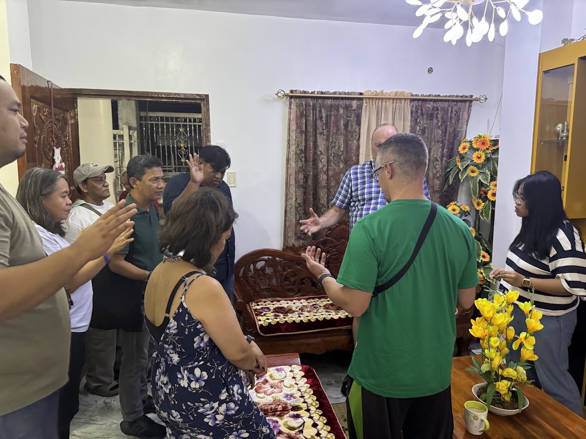The day ends in prayer — a circle in a family's home in Dasmariñas.