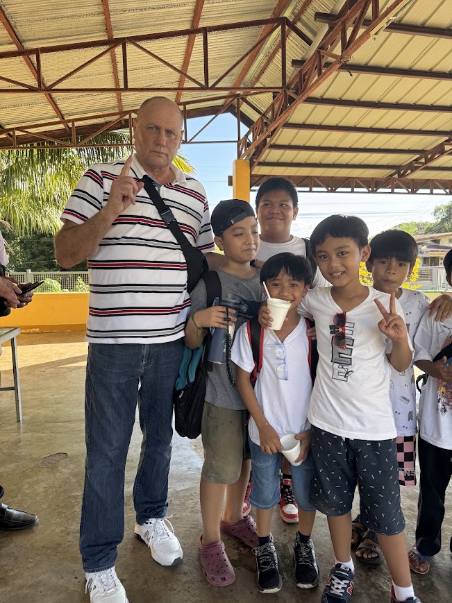 Sharing smiles and drinks with the children.